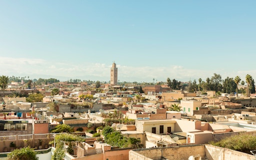 Marrakesh cityscape with Koutoubia Mosque tower in the background.
