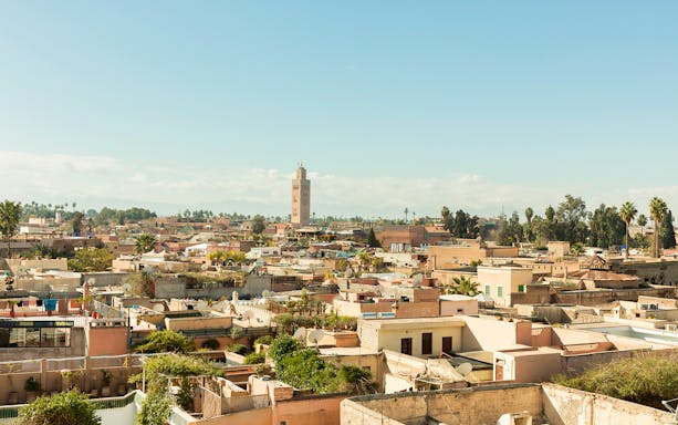 Marrakesh cityscape with Koutoubia Mosque tower in the background.