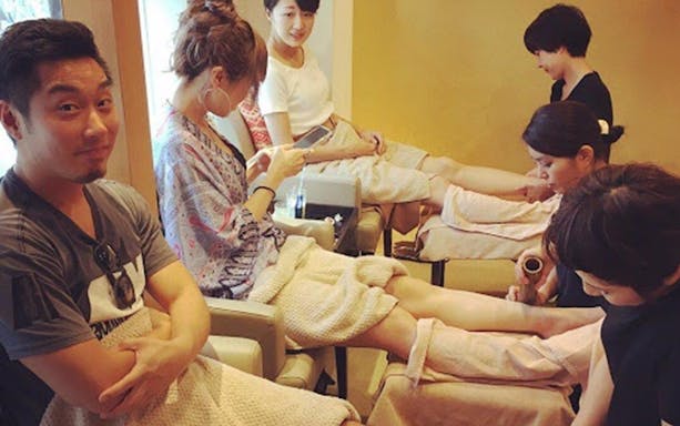 Guests enjoying Arashiyu Japanese foot massage in a relaxing spa setting.