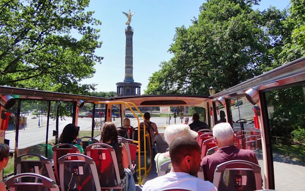 Open-top bus tour in Berlin passing the Victory Column.