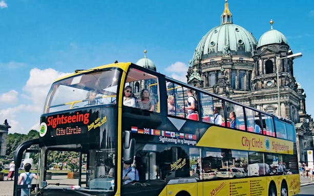 Open-top sightseeing bus in front of Berlin Cathedral on City Circle Hop-On Hop-Off tour.