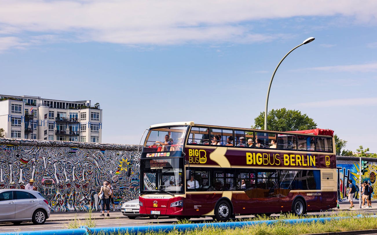Big Bus Berlin tour passing by the East Side Gallery, Berlin.