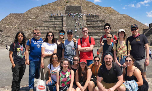 Group of tourists in front of Teotihuacán Pyramid during early access tour.
