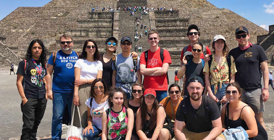 Group of tourists in front of Teotihuacán Pyramid during early access tour.