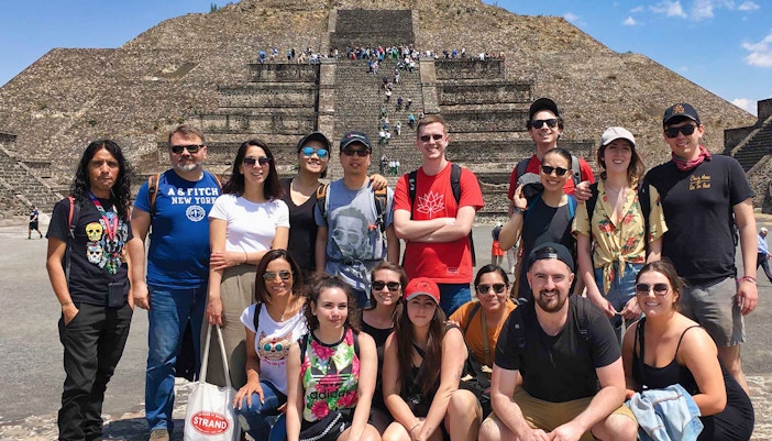 Group of tourists in front of Teotihuacán Pyramid during early access tour.