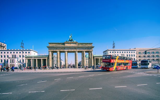 Hop-on hop-off bus in front of Brandenburg Gate, Berlin.
