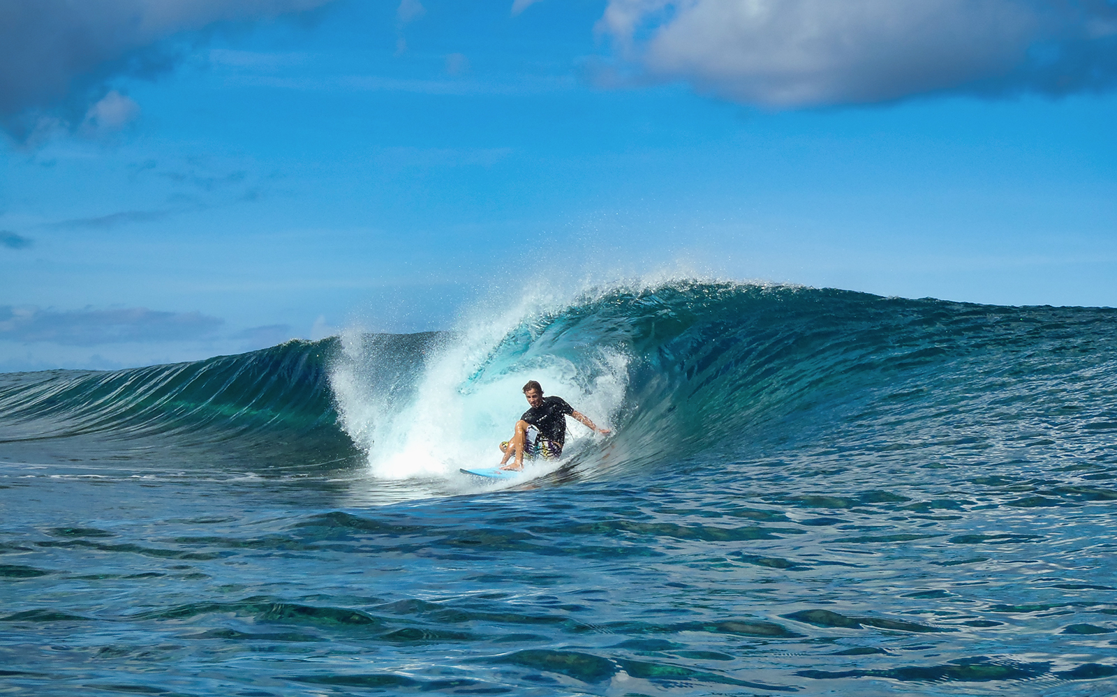 Surfer riding a wave in Chatan Town, Okinawa.