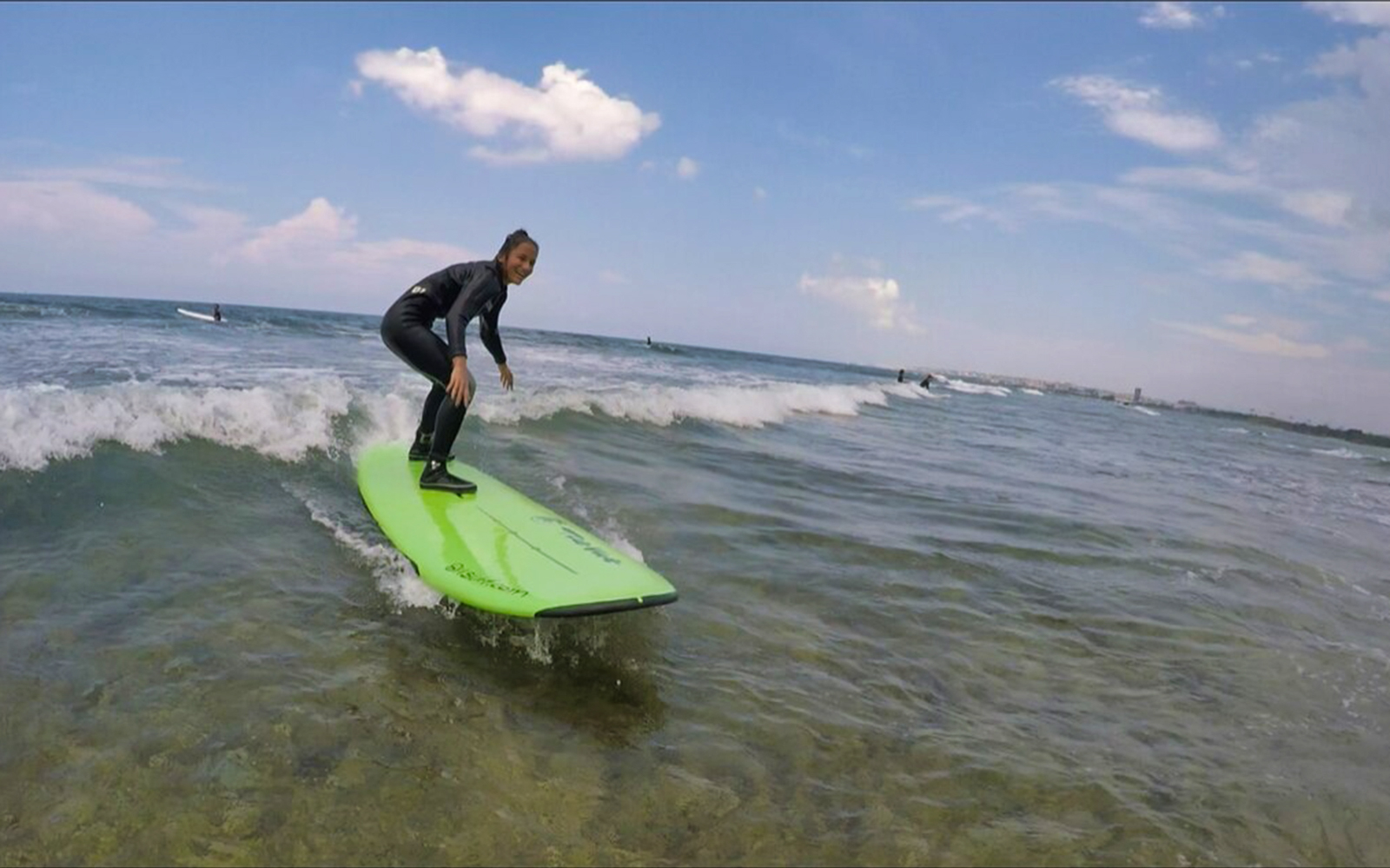 Surfer riding a wave in Chatan Town, Okinawa.