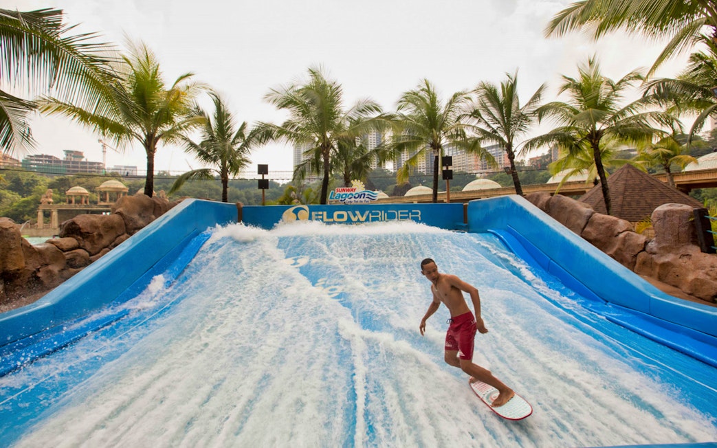 Surfer on FlowRider at Sunway Lagoon Theme Park, Malaysia.