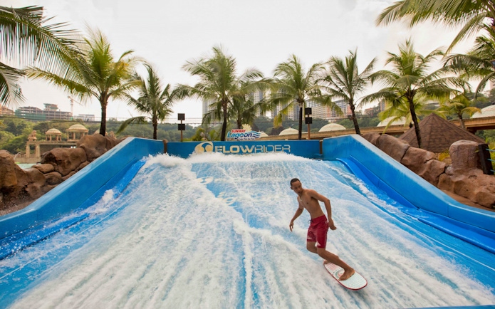 Surfer on FlowRider at Sunway Lagoon Theme Park, Malaysia.