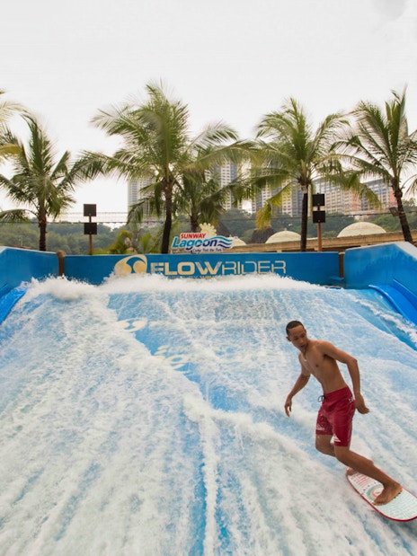 Surfer on FlowRider at Sunway Lagoon Theme Park, Malaysia.