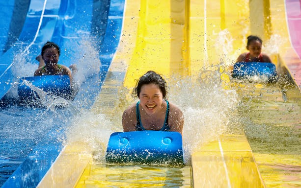 Visitors enjoying water slides at Escape Theme Park.