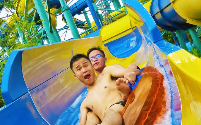 Visitors enjoying a water slide at Escape Theme Park.