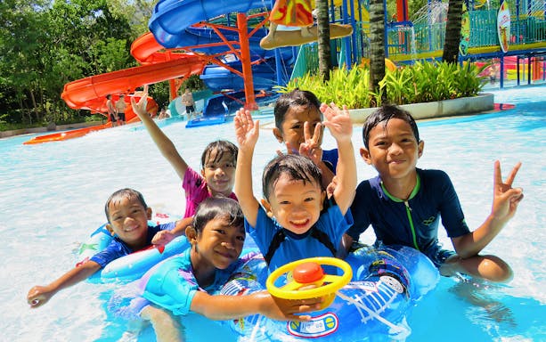 Children enjoying water slides at Escape Theme Park.