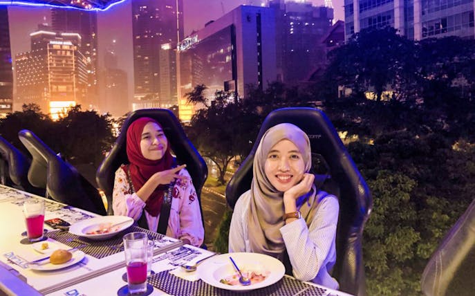 Dining experience at Dinner In The Sky Malaysia with city skyline backdrop.