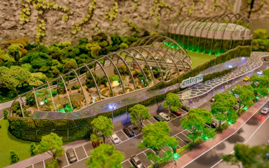 Entopia Penang Butterfly Farm entrance with lush greenery and parking area.