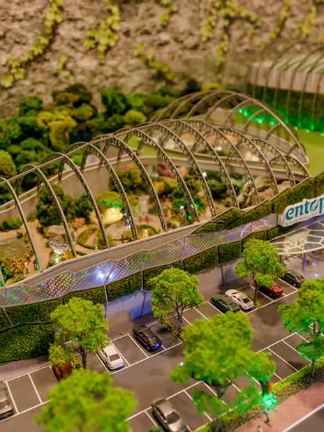 Entopia Penang Butterfly Farm entrance with lush greenery and parking area.