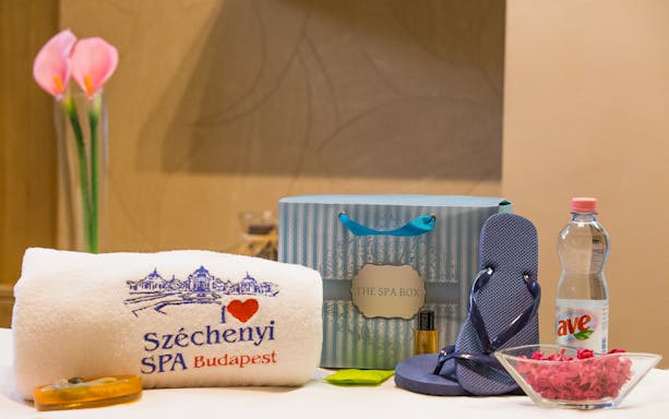 Széchenyi Spa essentials with towel, flip-flops, water bottle, and spa box in Budapest.