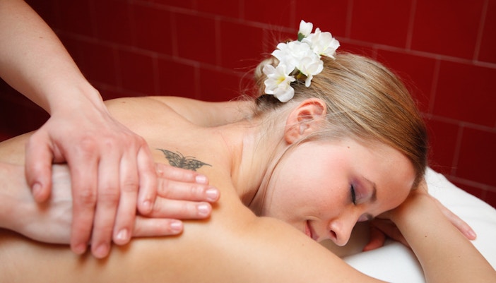 Tourists enjoying a relaxing massage at Széchenyi Spa in Budapest, Hungary with Skip the Line Ticket and Private Cabin