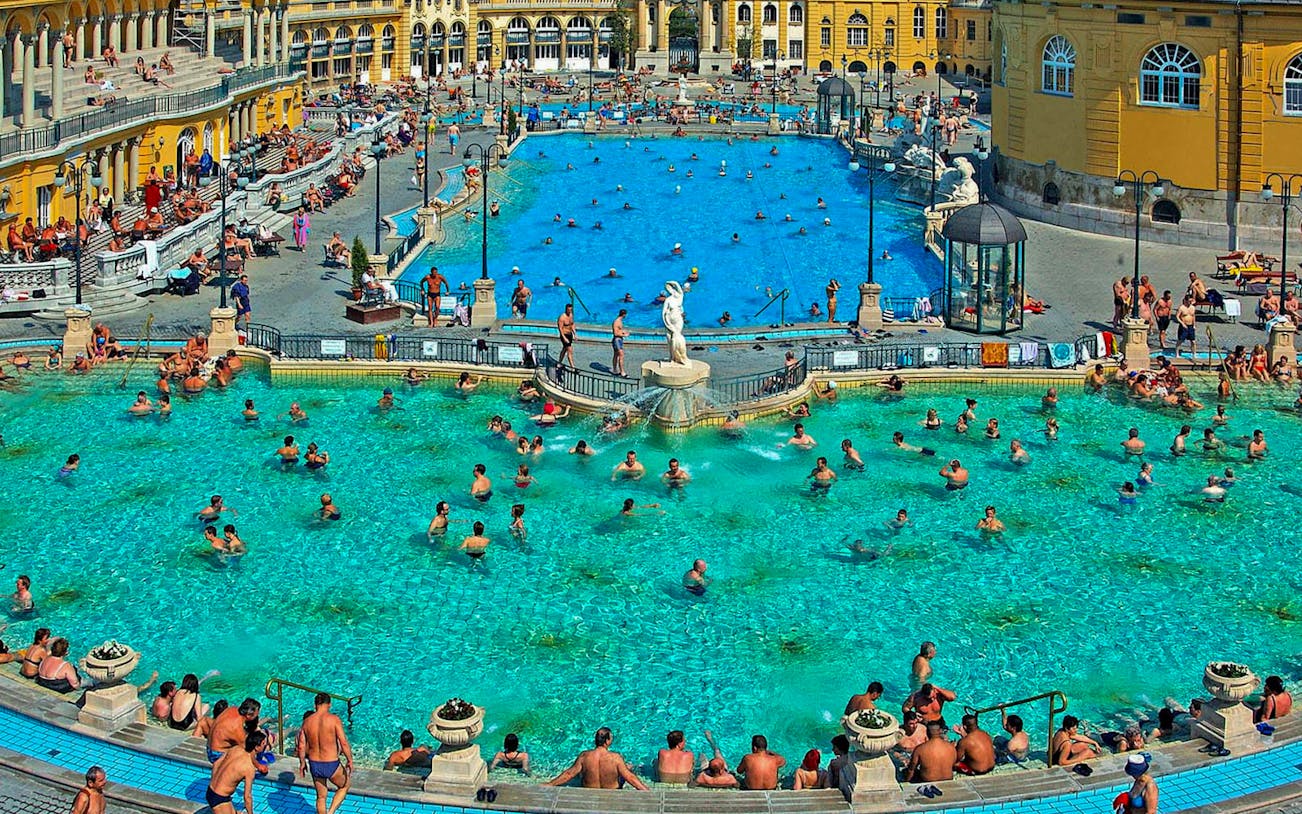 Visitors enjoying thermal pools at Széchenyi Spa, Budapest.