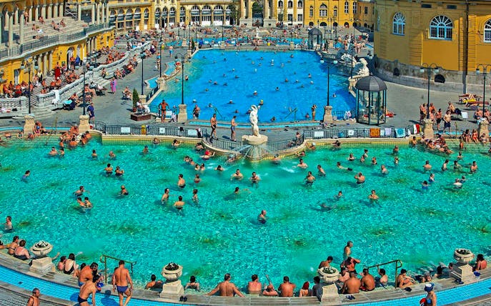Visitors enjoying thermal pools at Széchenyi Spa, Budapest.