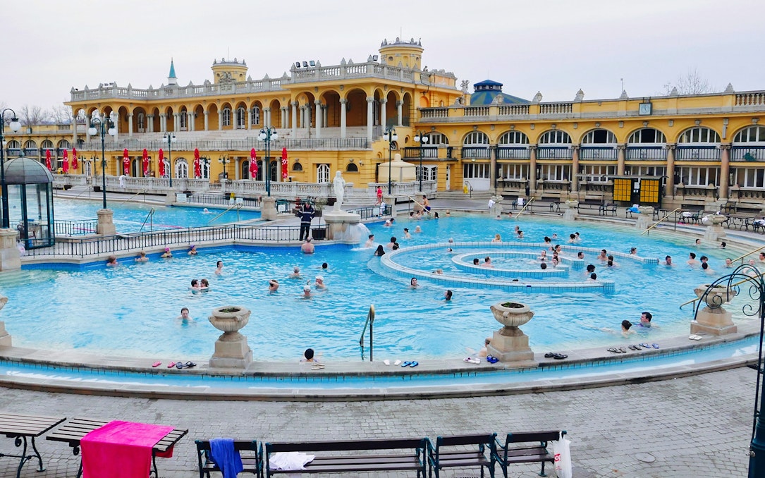 Visitors enjoying the thermal pools at Széchenyi Spa, Budapest.