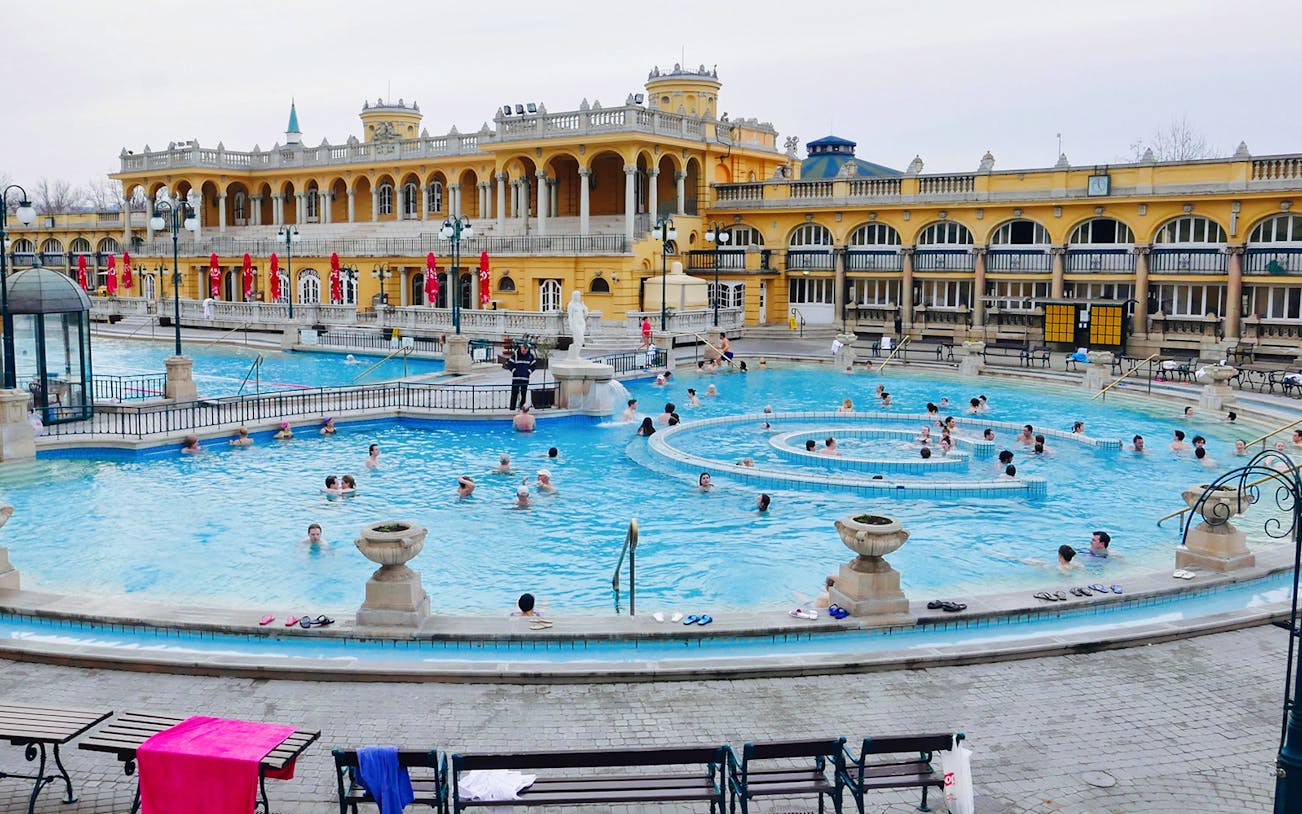 Visitors enjoying the thermal pools at Széchenyi Spa, Budapest.