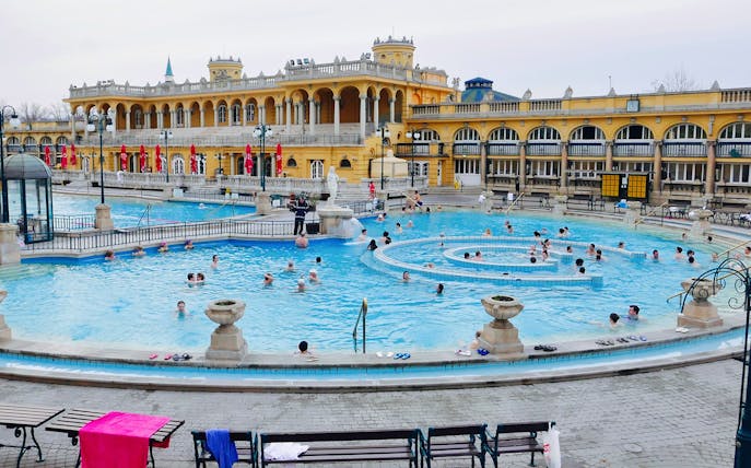 Visitors enjoying the thermal pools at Széchenyi Spa, Budapest.