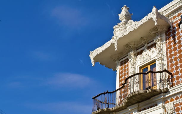 Ornate balcony and facade detail in Puebla, Mexico.