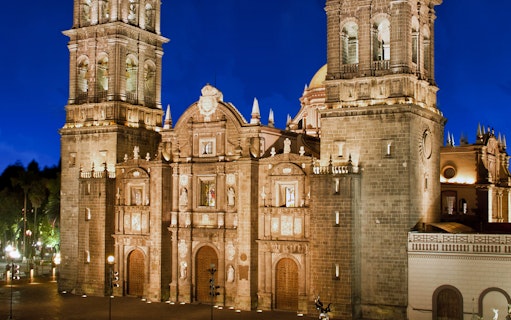 Puebla Cathedral illuminated at night, featured on the Puebla & Cholula Day Tour from Mexico City.