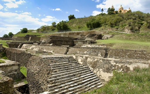 Ancient pyramid ruins in Cholula with a church on the hill, Puebla, Mexico.