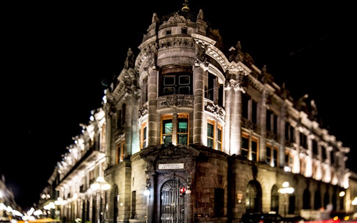 Historic building illuminated at night in Puebla, Mexico, part of the Puebla & Cholula Day Tour.
