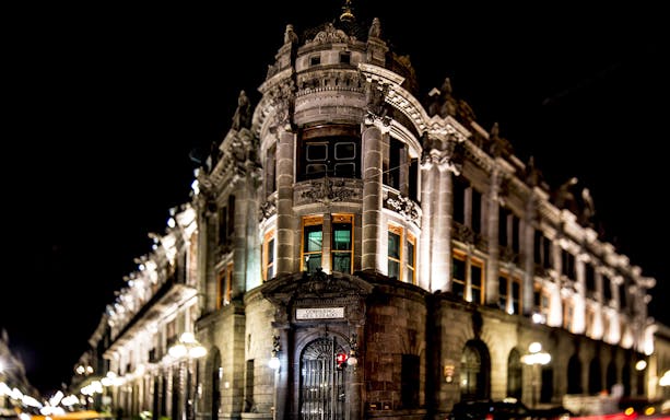 Historic building illuminated at night in Puebla, Mexico, part of the Puebla & Cholula Day Tour.