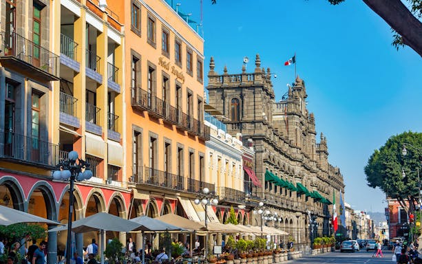 Colorful colonial buildings and street scene in Puebla, Mexico, part of the Puebla & Cholula Day Tour.