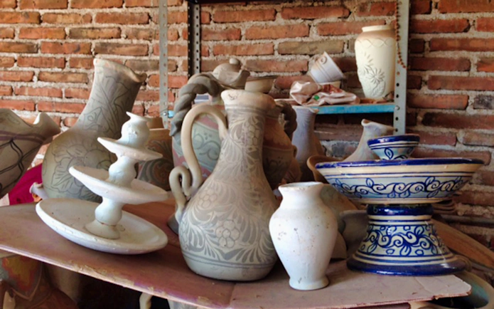 Handcrafted pottery in a Puebla workshop, featuring traditional designs and patterns.