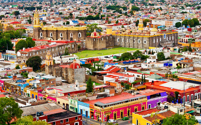 Aerial view of Cholula with colorful buildings and the Great Pyramid in Puebla, Mexico.