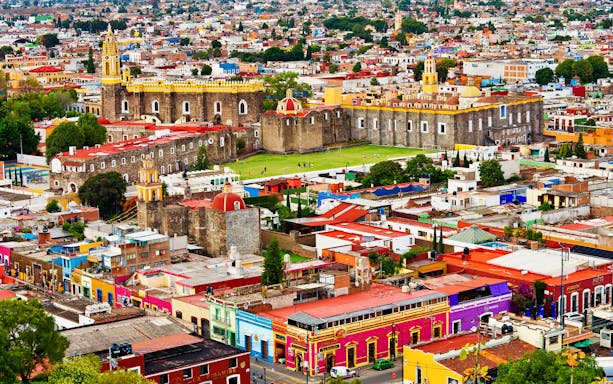 Aerial view of Cholula with colorful buildings and the Great Pyramid in Puebla, Mexico.