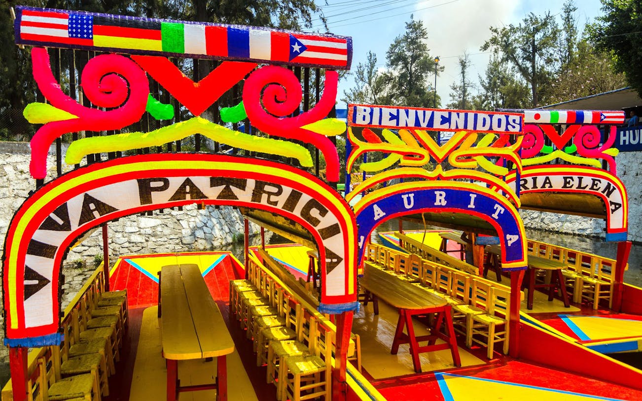 Colorful trajineras in Xochimilco, Mexico City, part of the Xochimilco & Coyoacan Full Day Guided Tour.
