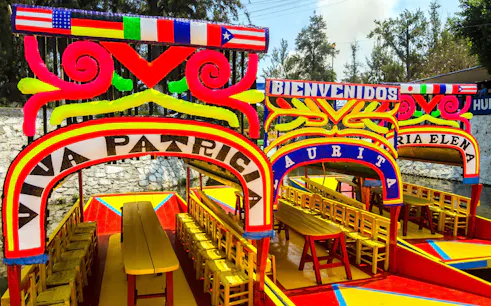 Colorful trajineras in Xochimilco, Mexico City, part of the Xochimilco & Coyoacan Full Day Guided Tour.