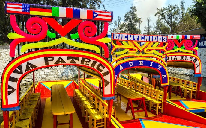 Colorful trajineras in Xochimilco, Mexico City, part of the Xochimilco & Coyoacan Full Day Guided Tour.