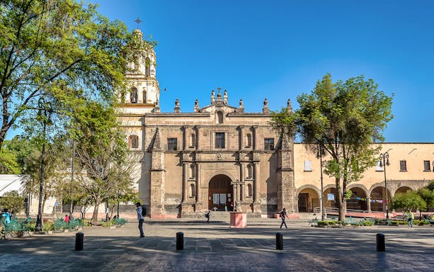 Coyoacan's historic church facade on a sunny day, part of the Xochimilco & Coyoacan tour.