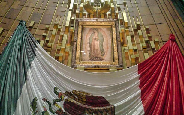 Guadalupe image with Mexican flag at Basílica, Mexico City.