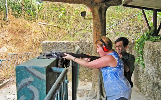 Visitor trying shooting experience at Cu Chi Tunnels, Ho Chi Minh City.