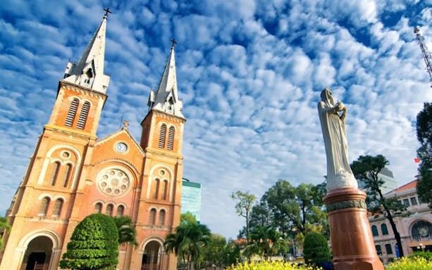 Notre-Dame Cathedral Basilica in Ho Chi Minh City with Virgin Mary statue.