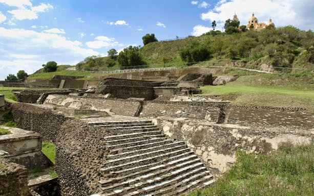 Ancient pyramid ruins with a church on a hill in Cholula, Mexico City tour.