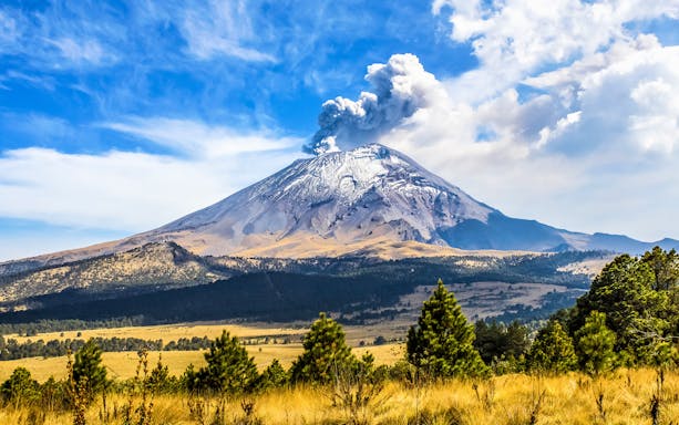 Popocatépetl volcano with smoke plume in Iztaccíhuatl-Popocatépetl National Park.