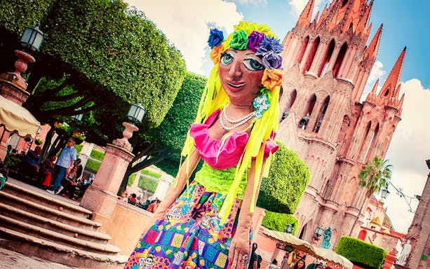 Giant puppet in colorful attire near Parroquia de San Miguel Arcángel, San Miguel de Allende.