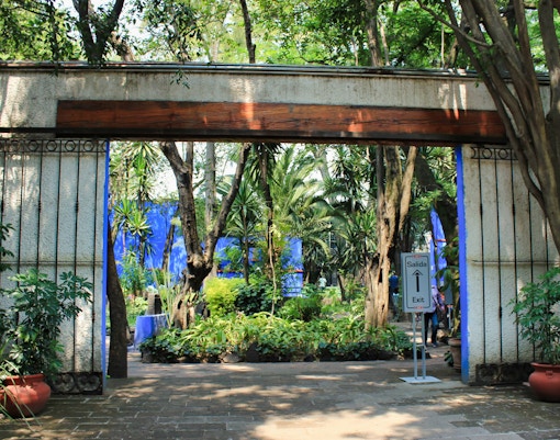 Frida Kahlo Museum entrance with visitors in Mexico City during guided tour.