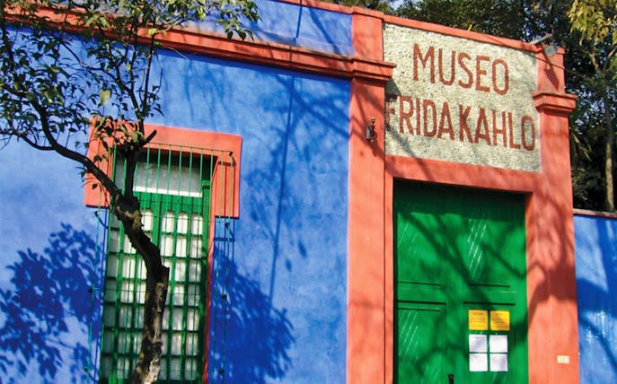 Frida Kahlo Museum entrance with blue walls and green door in Mexico City.
