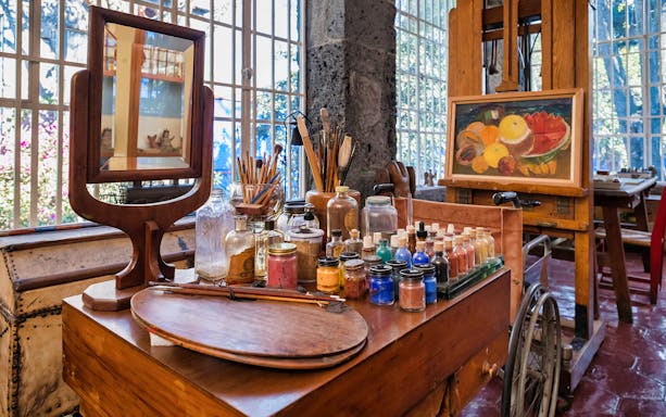 Art supplies and easel in Frida Kahlo Museum studio, Mexico City.